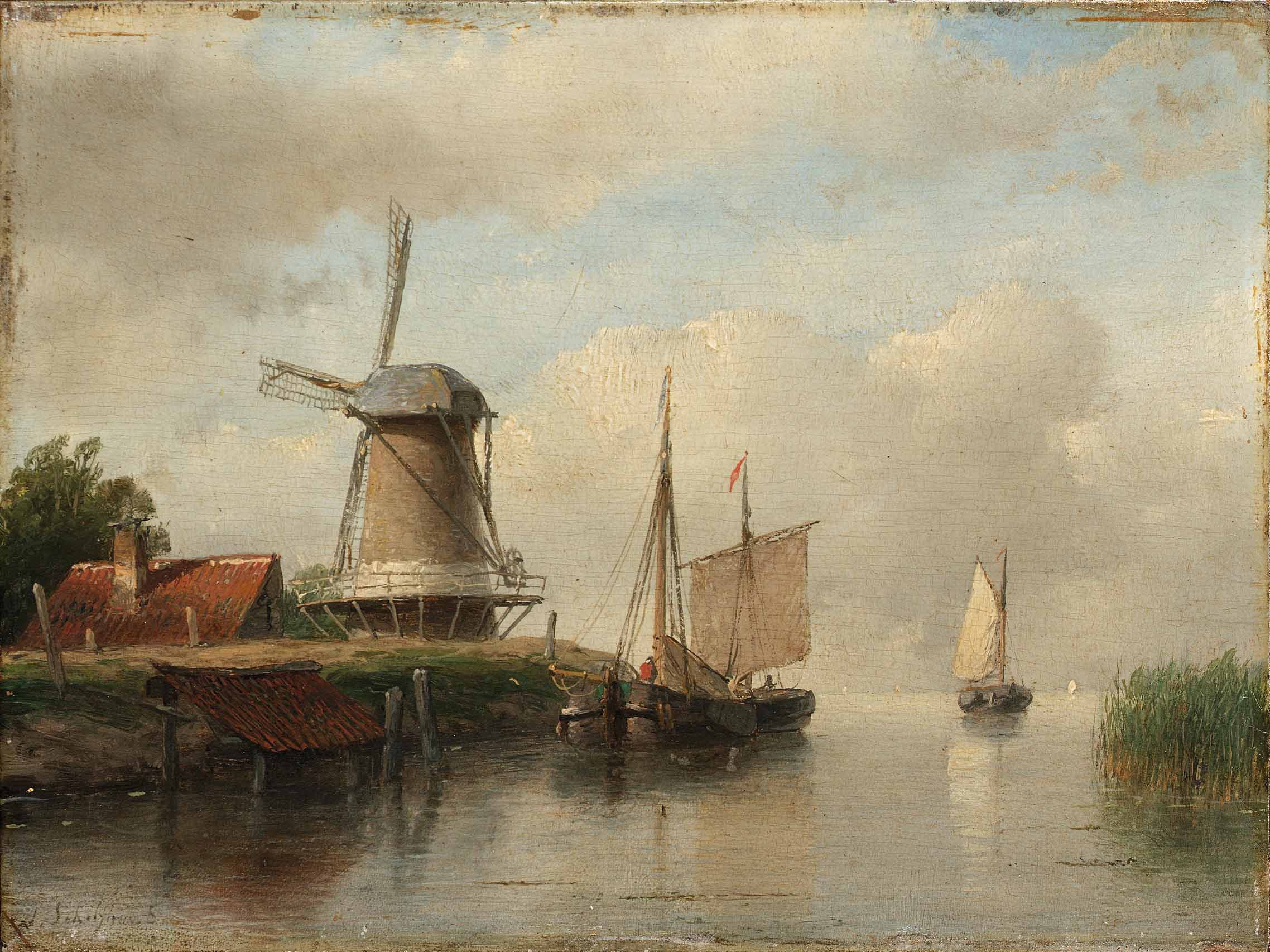 Dutch boats moored on a river beside a windmill